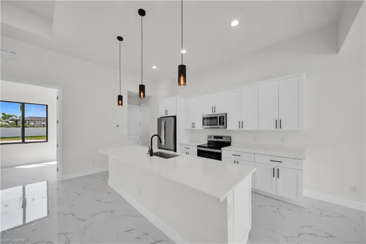 Kitchen featuring marble finish floor, a sink, stainless steel appliances, and visible vents