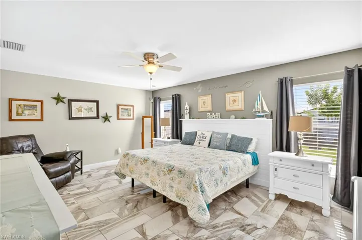 Bedroom with ceiling fan and baseboards