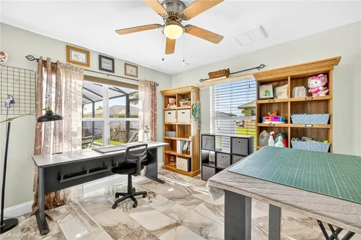 Home office featuring healthy amount of natural light and a ceiling fan