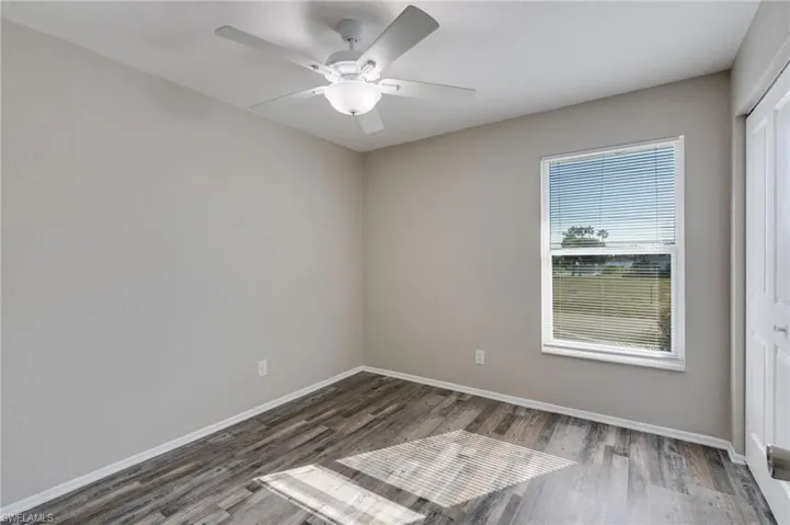 Unfurnished room with light wood-type flooring and ceiling fan