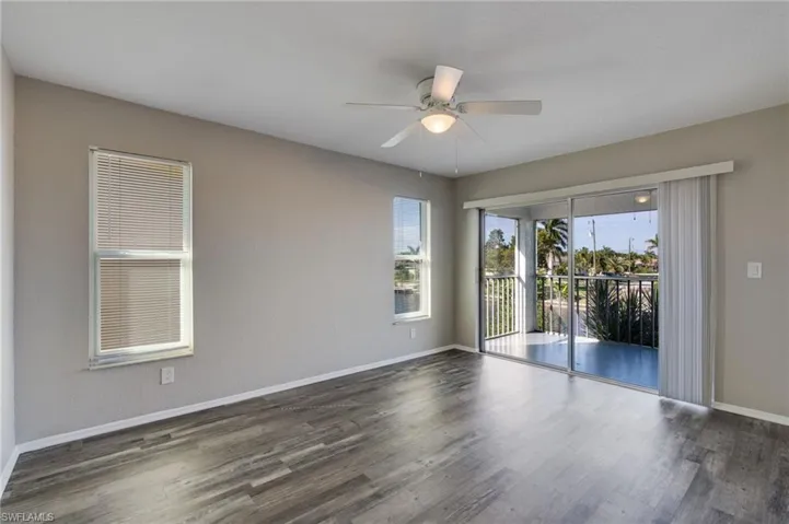 Spare room with wood finished floors and a ceiling fan