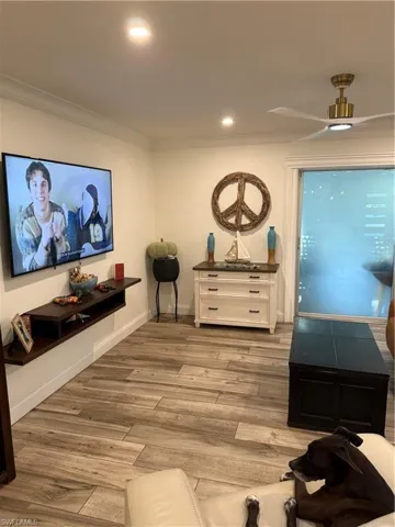 Cinema featuring light wood-style floors, ornamental molding, ceiling fan, and recessed lighting