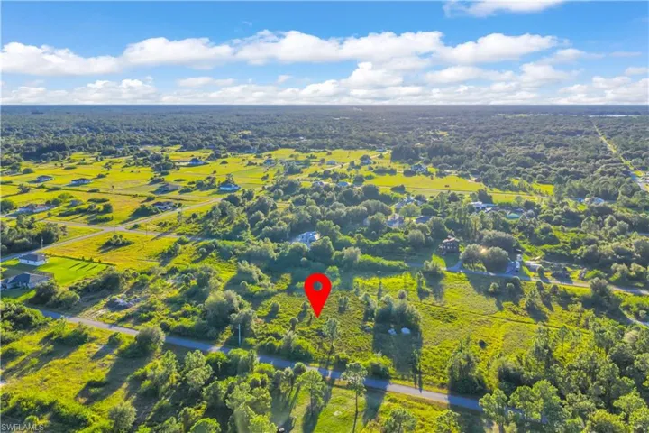 Aerial view of sparsely populated area with a heavily wooded area