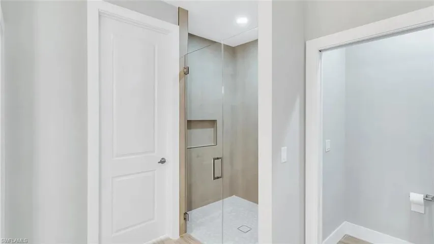 Bathroom featuring a stall shower and recessed lighting
