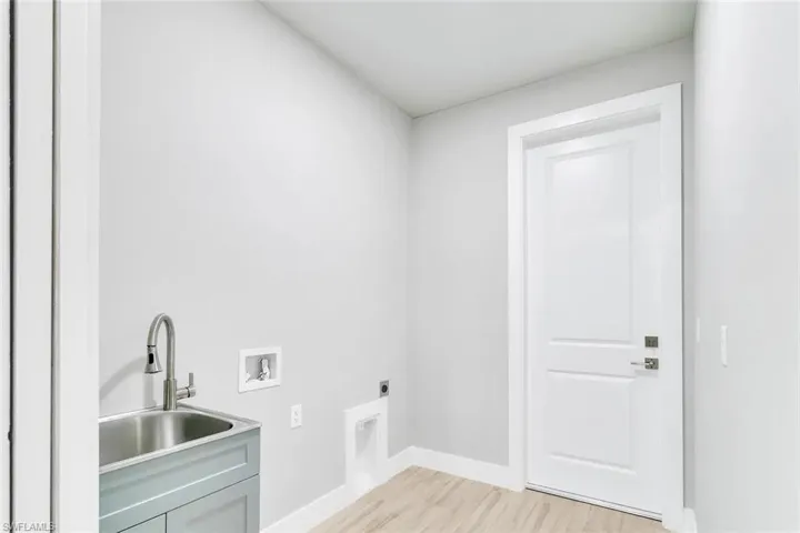 Laundry room featuring washer hookup, light wood-type flooring, and electric dryer hookup