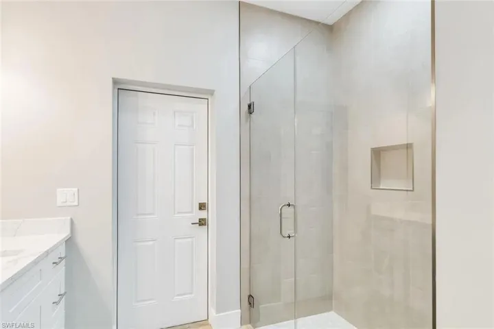 Full bath featuring vanity and a shower stall