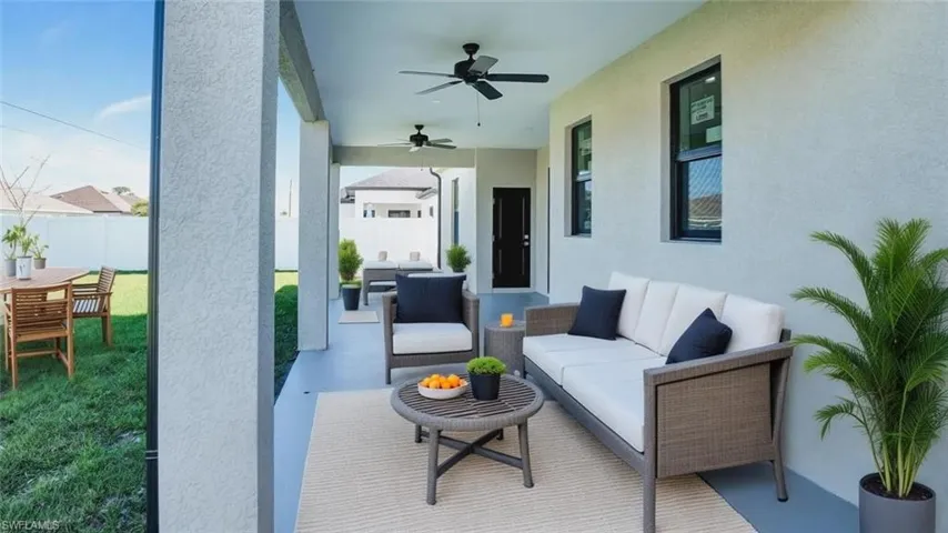 View of patio with ceiling fan and an outdoor living / dining area
