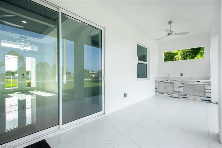 View of patio / terrace with ceiling fan and an outdoor kitchen