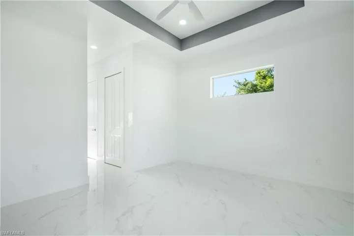 Empty room with tile patterned flooring and ceiling fan