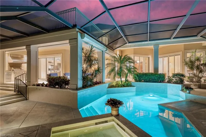 Swimming pool featuring exterior kitchen and a patio
