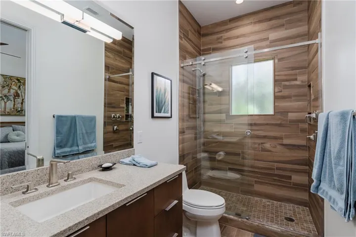 Full bathroom with vanity and a stall shower