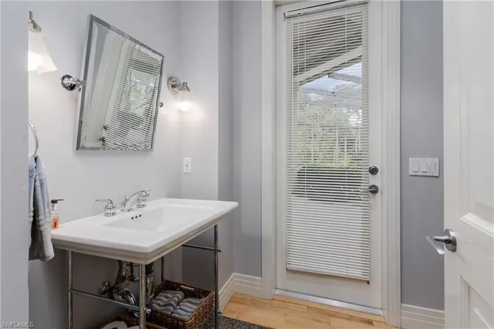 Bathroom with wood finished floors and baseboards