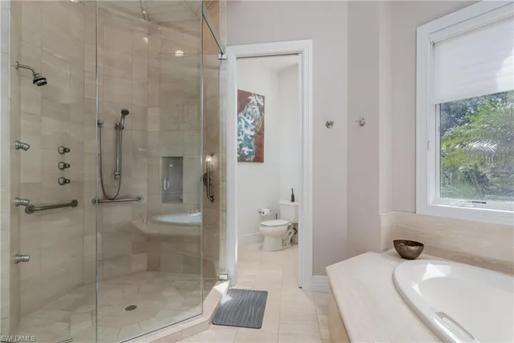 Bathroom featuring a shower stall, a bath, and tile patterned floors