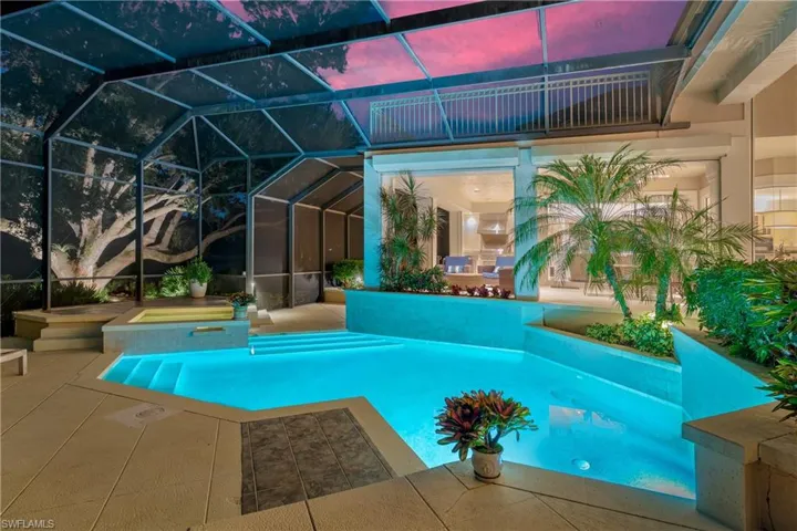 View of pool featuring a patio, a lanai, and a pool with connected hot tub