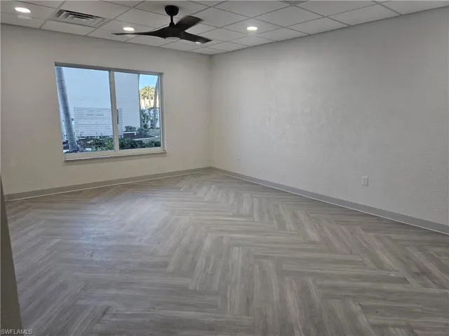 Newly remodeled community room featuring recessed lighting, modern ceiling fan, and stylish parquet floors