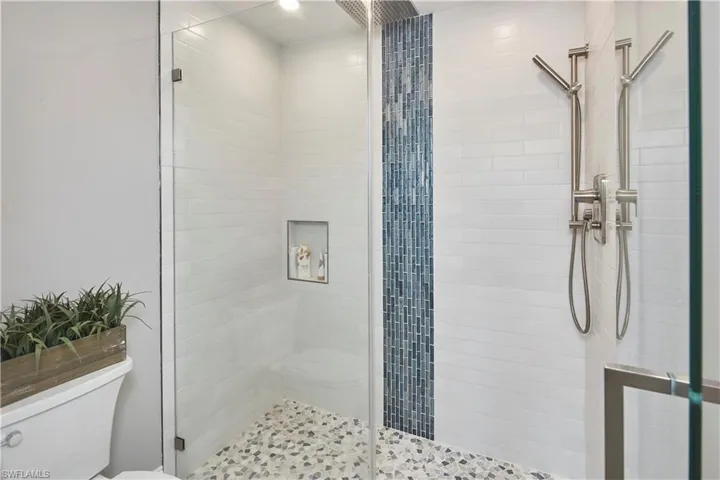 Refresh and rejuvenate in this beautiful shower with custom tile.