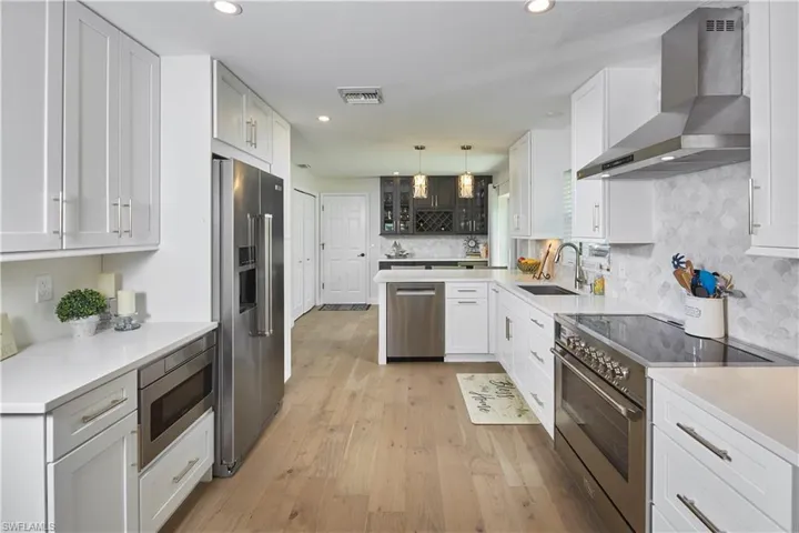 Kitchen features a Verona 36" induction range, Bosch dishwasher, Kitchen-Aid counter depth refrigerator AND a 50 bottle wine cooler!