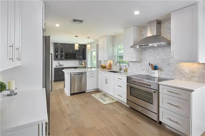 Beautiful quartz countertops throughout the kitchen & custom backsplash.