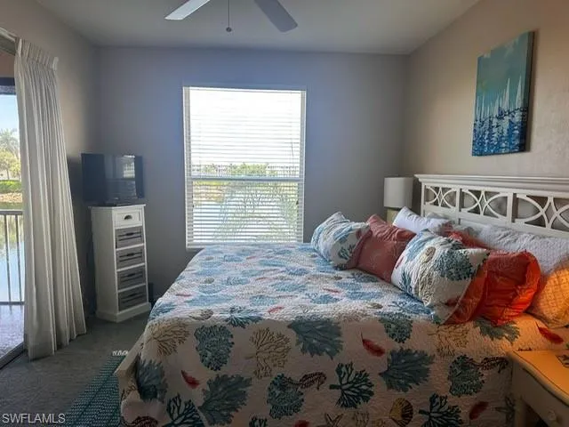 Bedroom featuring access to outside, carpet, and ceiling fan