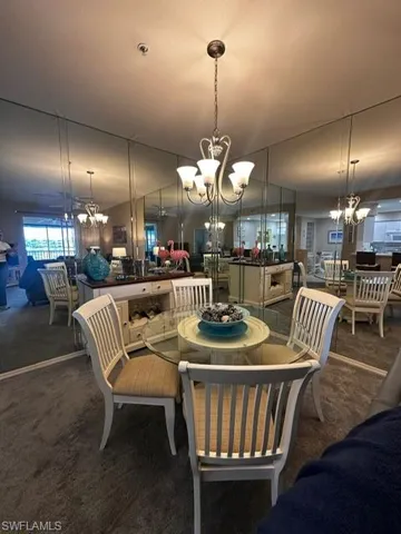Dining space with a chandelier and carpet