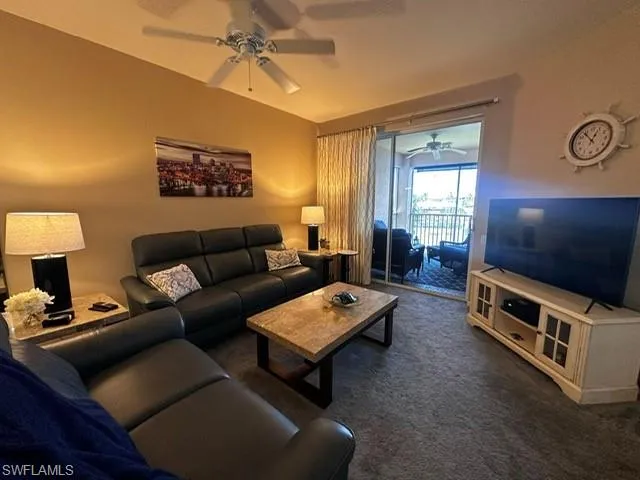 Living area with a ceiling fan and carpet