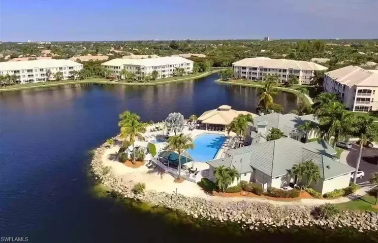 Drone / aerial view of apartment complex and a nearby body of water
