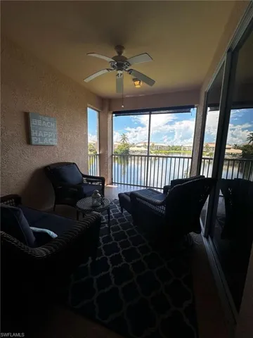 Sunroom featuring a textured wall and a water view