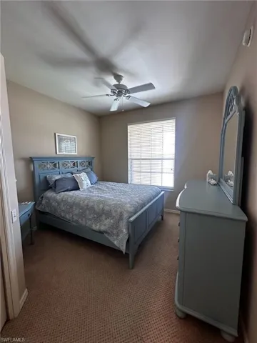 Bedroom with carpet and a ceiling fan