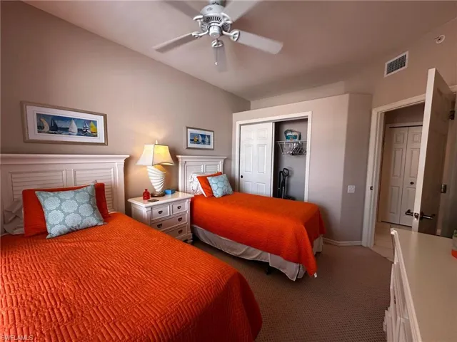 Bedroom featuring carpet floors, a closet, and ceiling fan