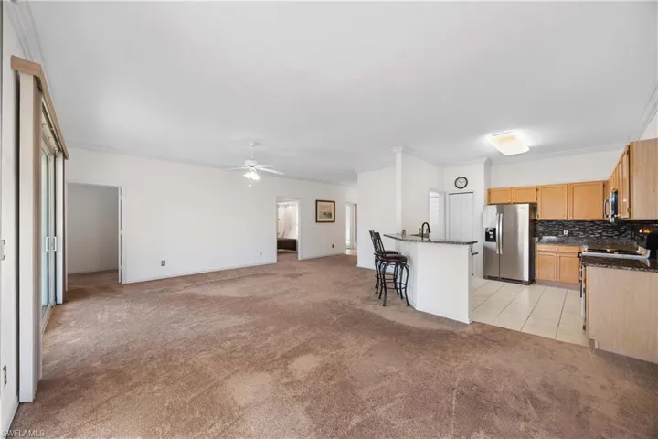 Open Great room with crown molding, stainless steel appliances and new granite countertops
