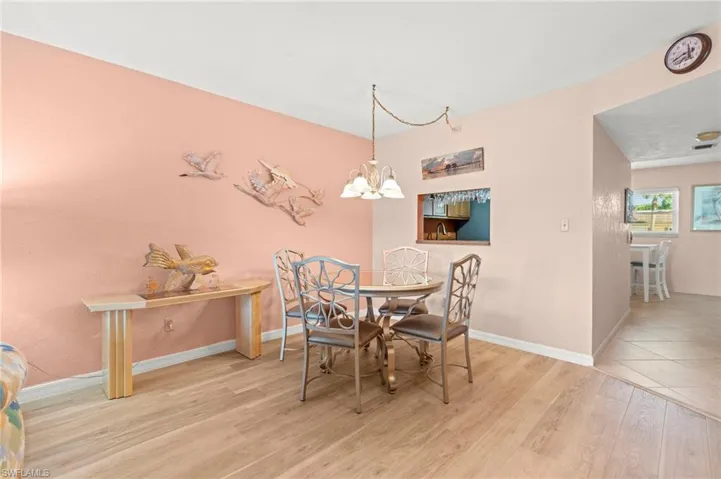 Dining space featuring light wood-style flooring and a chandelier
