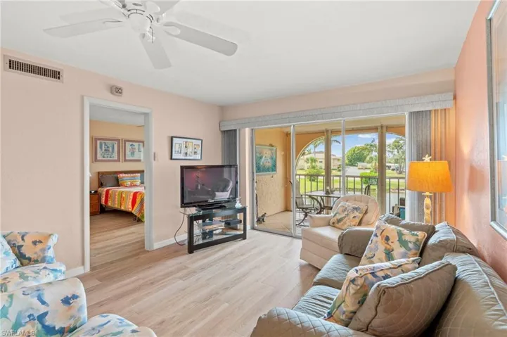 light wood finished floors and a ceiling fan