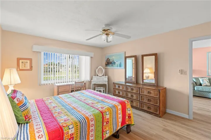 Master Bedroom with light wood finished floors and a ceiling fan