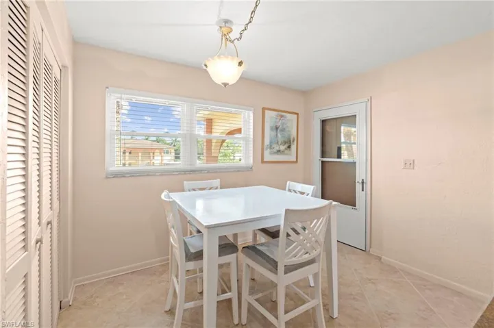 Dining space featuring light tile patterned floors and baseboards