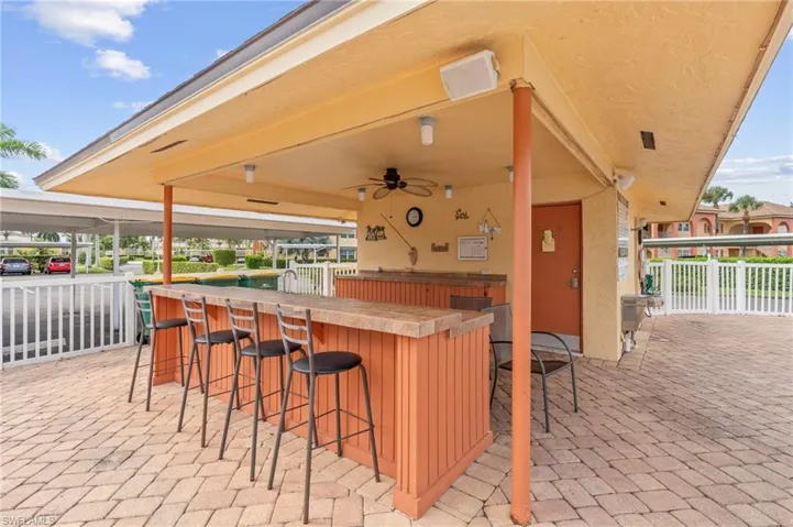 View of patio / terrace with a bar and a ceiling fan