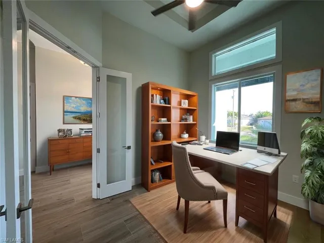 Office featuring french doors, wood finished floors, and a ceiling fan