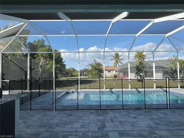 Outdoor pool with a lanai and a patio