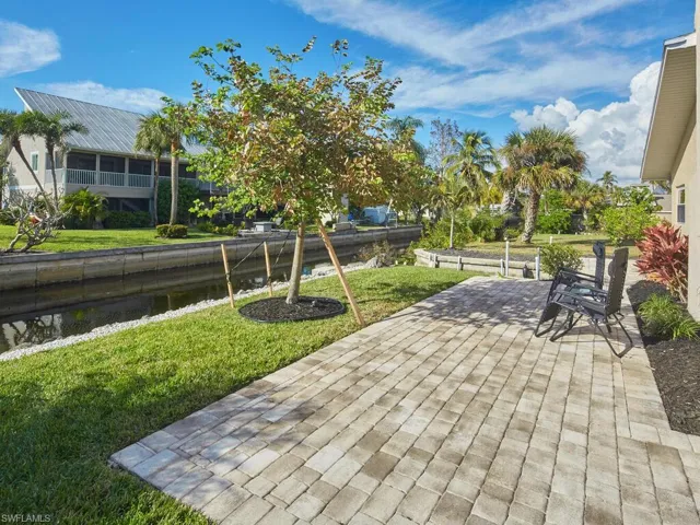 Home features a large patio overlooking the canal.