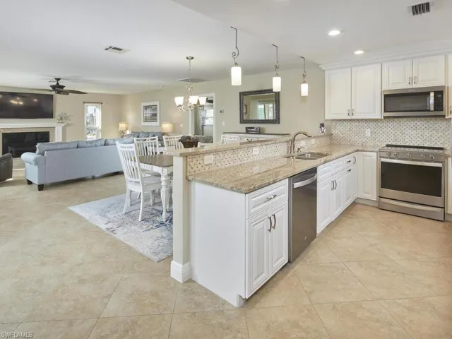 Kitchen, dining room, and living room are open to one another.