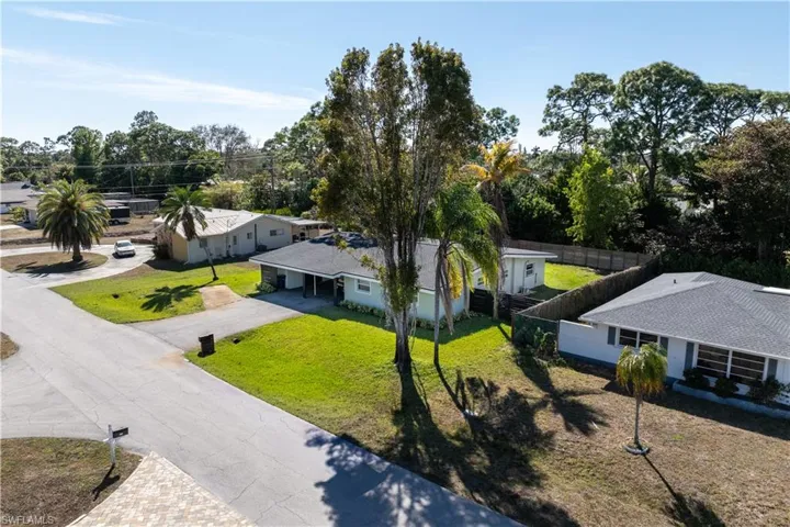 View from above of property with a tree filled landscape