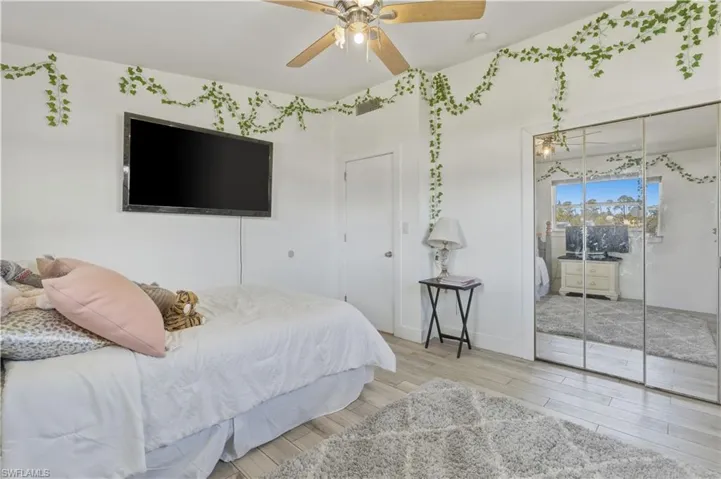 Bedroom with light wood finished floors and a ceiling fan
