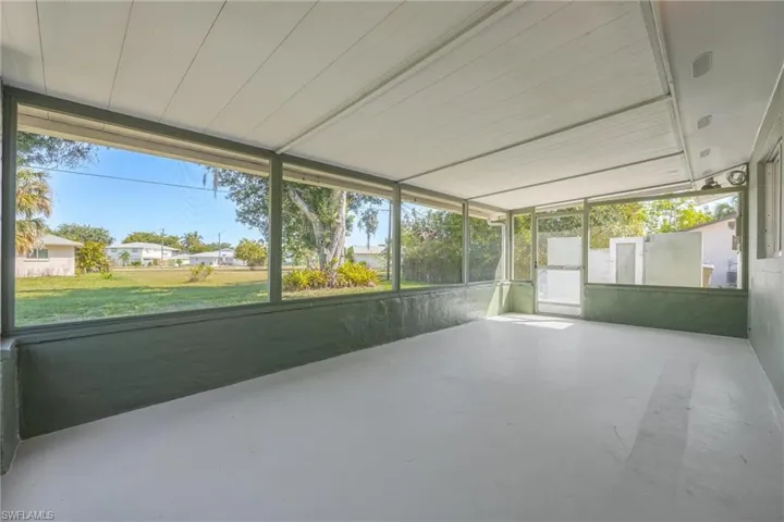 Unfurnished sunroom featuring a residential view
