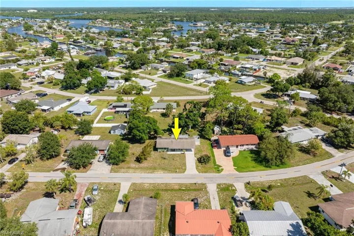 Aerial overview of property's location with nearby suburban area and a nearby body of water