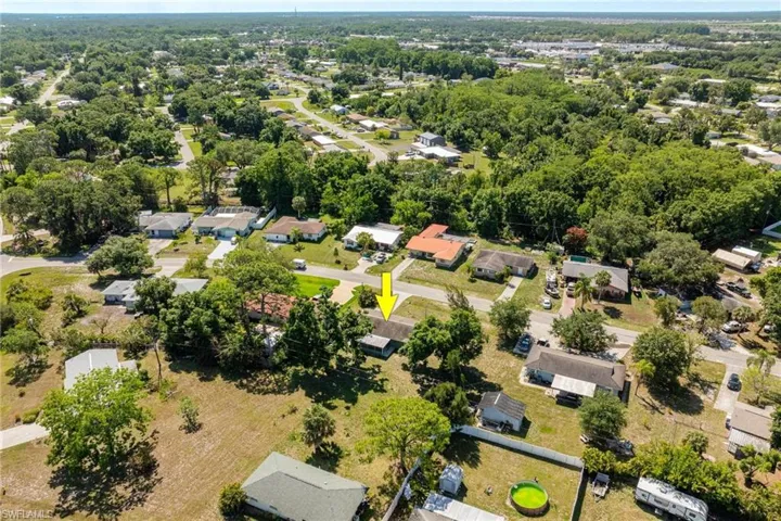 Aerial view of property's location with nearby suburban area