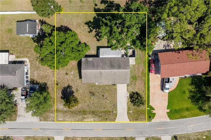 Aerial view of property and surrounding area with property parcel outlined