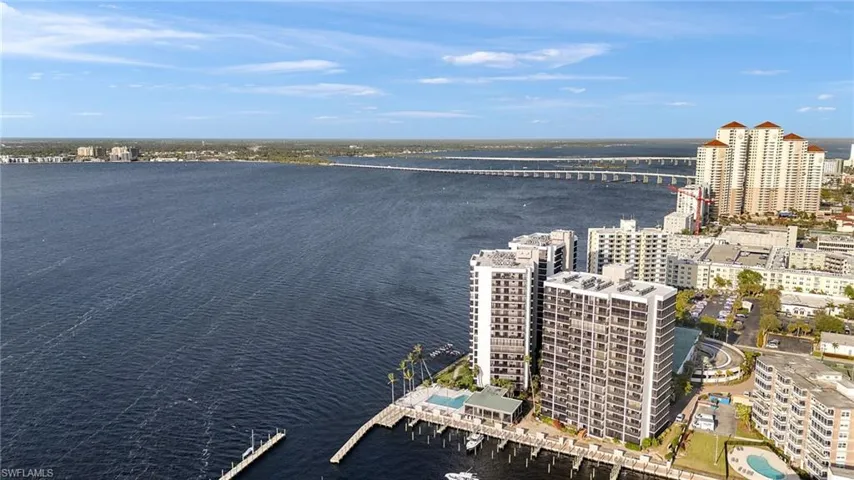 Birds eye view of property with a water view