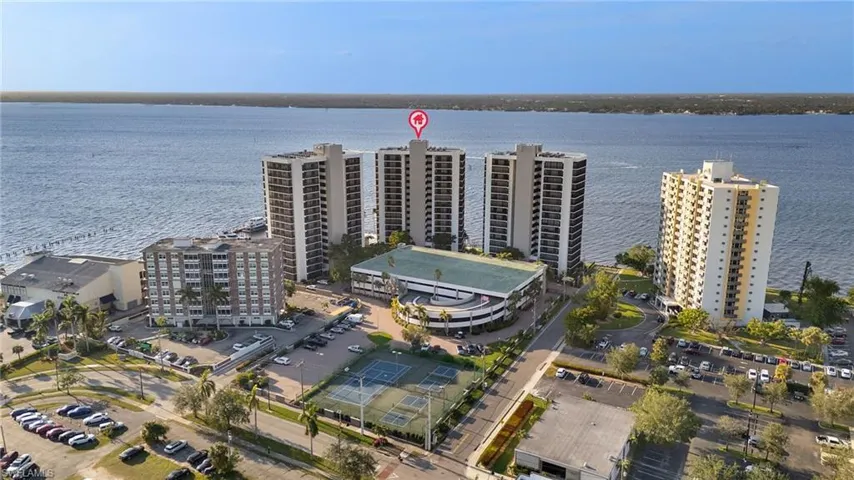 Birds eye view of property with a water view