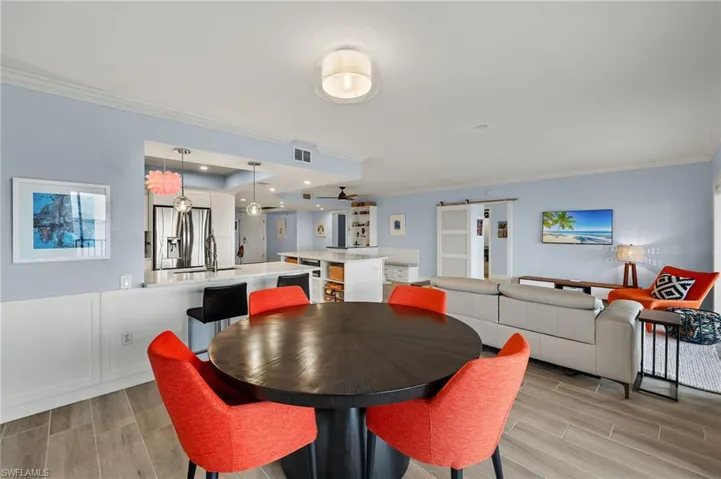 Dining space featuring ornamental molding and sink