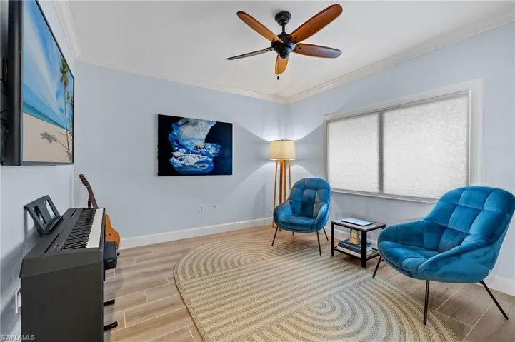Sitting room featuring crown molding and ceiling fan