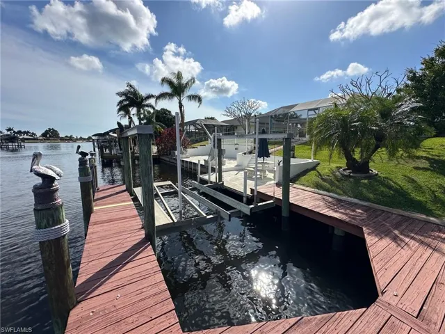 Dock area with a water view and boat lift